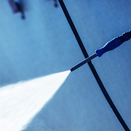 Hand Car Wash Cleaning. Bluish Color Grading. Cleaning Modern Compact Car.